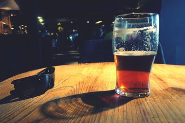 Beer In Glass By Sunglasses On Table