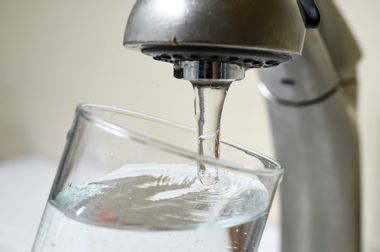 Tap water in a clear glass drinking glass.