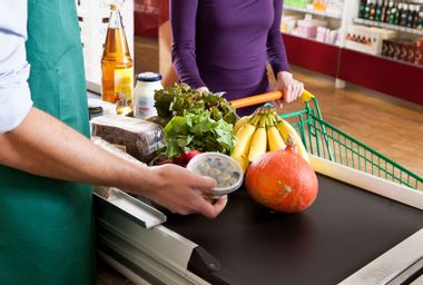 A cashier and customer at the checkout line of a supermarket